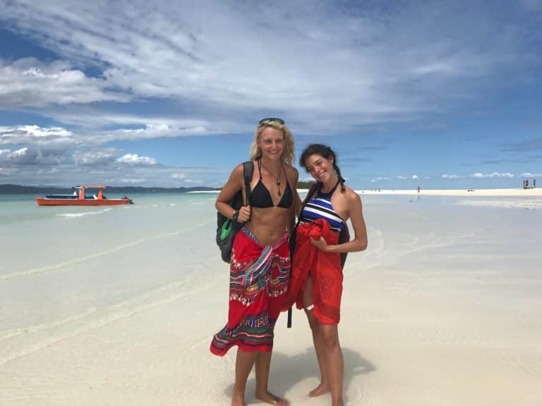 two girls standing on the beach